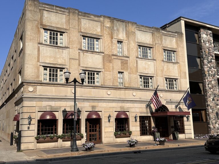 The Bell Tower Hotel on South Thayer Street, stone facade with burgundy awnings, a block from the Diag